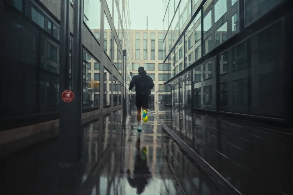 Runner sprinting through wet Zurich street reflecting city lights